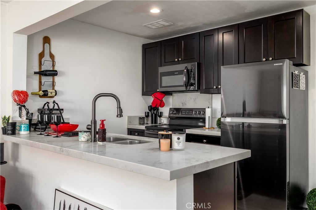 3088 Panorama Road, Unit D Riverside, CA 92506 - Photo 5 of 13 a kitchen with stainless steel appliances and refrigerator