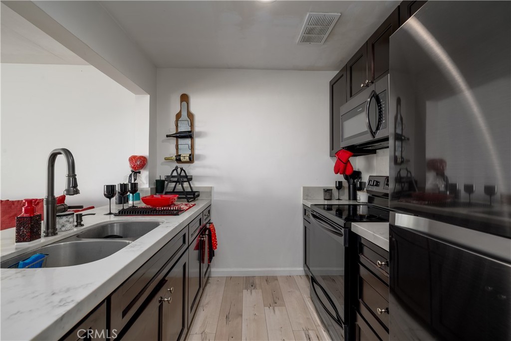 3088 Panorama Road, Unit D Riverside, CA 92506 - Photo 7 of 13 a kitchen with sink a stove and wooden floor