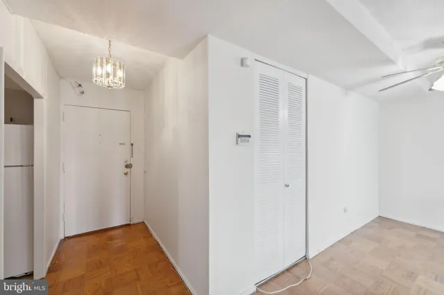 a view of an empty room with a fireplace and a window