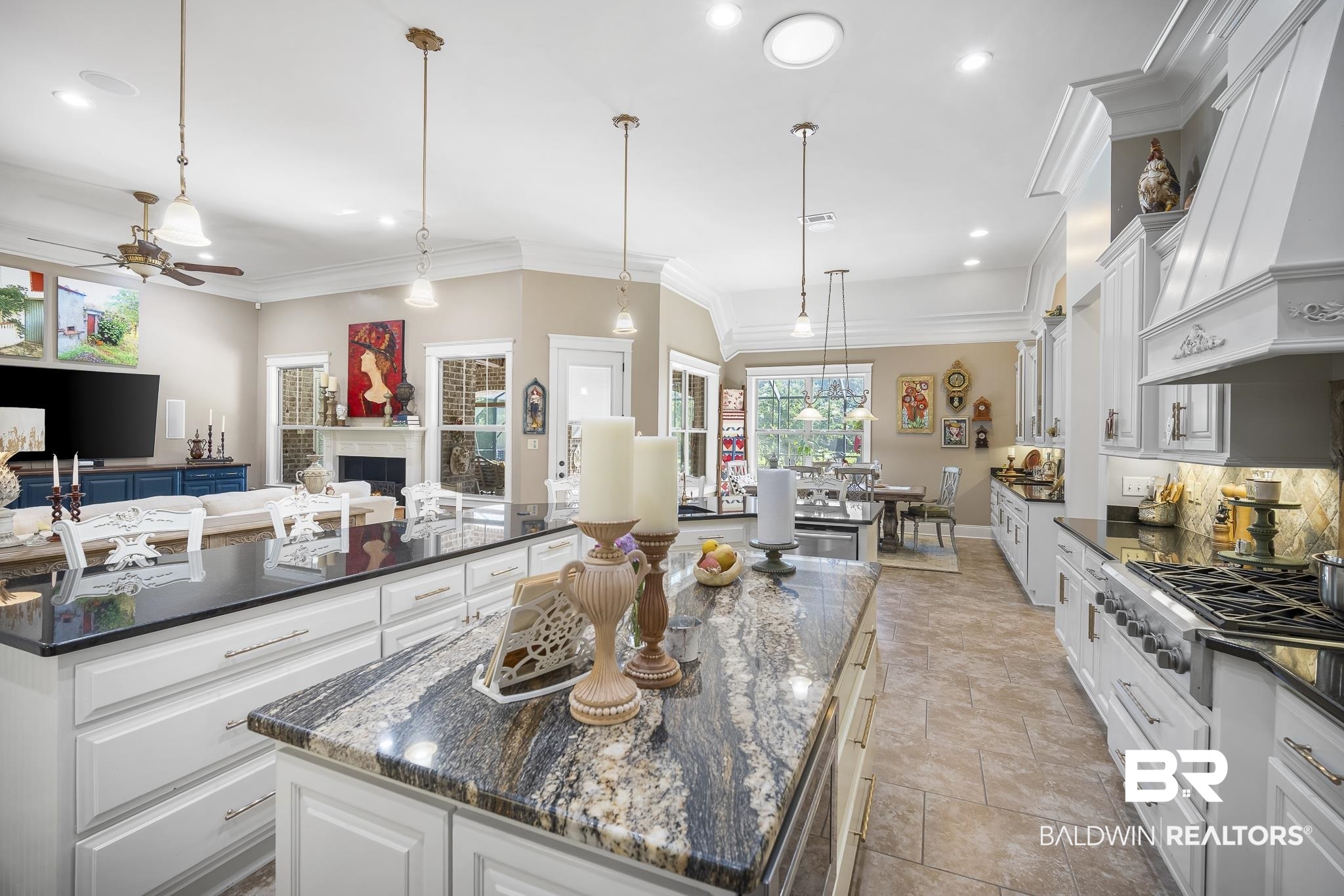 25212 Austin Road Daphne, AL 36526 - Photo 56 of 56 Kitchen with white cabinetry, decorative light fixtures, dark stone counters, open floor plan, and custom range hood