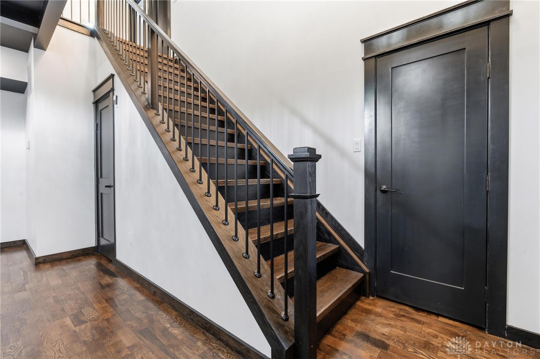3509 South State Rte 72 Sabina, OH 45169 - Photo 22 of 44 Elegant wooden staircase with dark iron balusters and hardwood floors welcomes you inside.