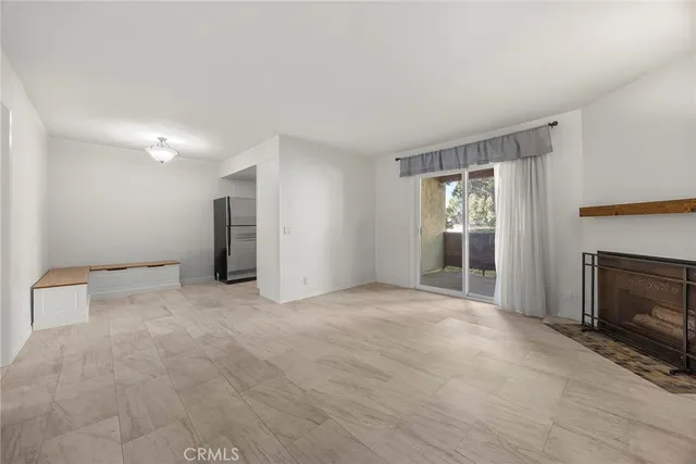 a view of empty room with a fireplace