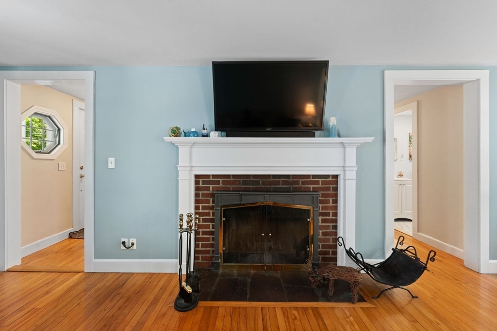 12 Millbrook Road Westwood, MA 02090 - Photo 11 of 28 a living room with a fireplace and a flat screen tv