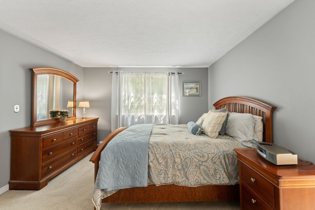 12 Millbrook Road Westwood, MA 02090 - Photo 15 of 28 a bedroom with a bed and a mirror on dresser