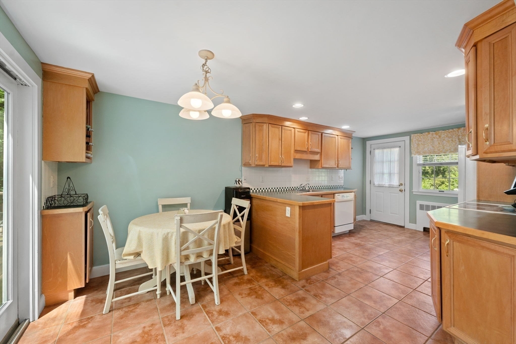 12 Millbrook Road Westwood, MA 02090 - Photo 6 of 28 a kitchen with a table and chairs in it