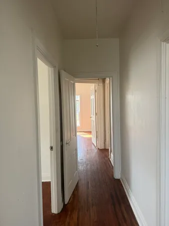 a view of a hallway with wooden floor