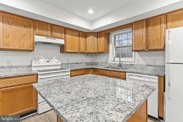 a kitchen with a stove a sink and a refrigerator