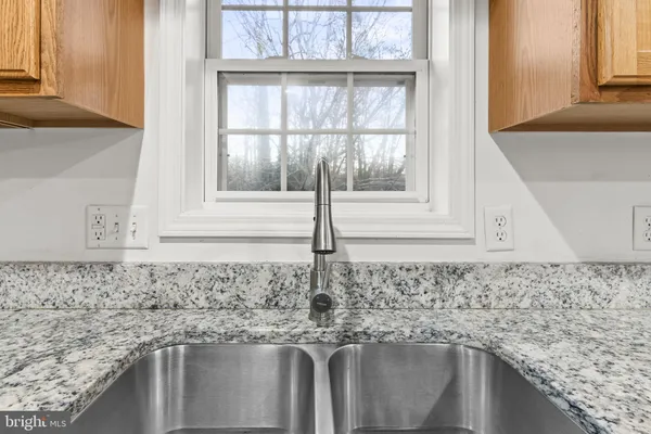 a kitchen with granite countertop a sink and a window