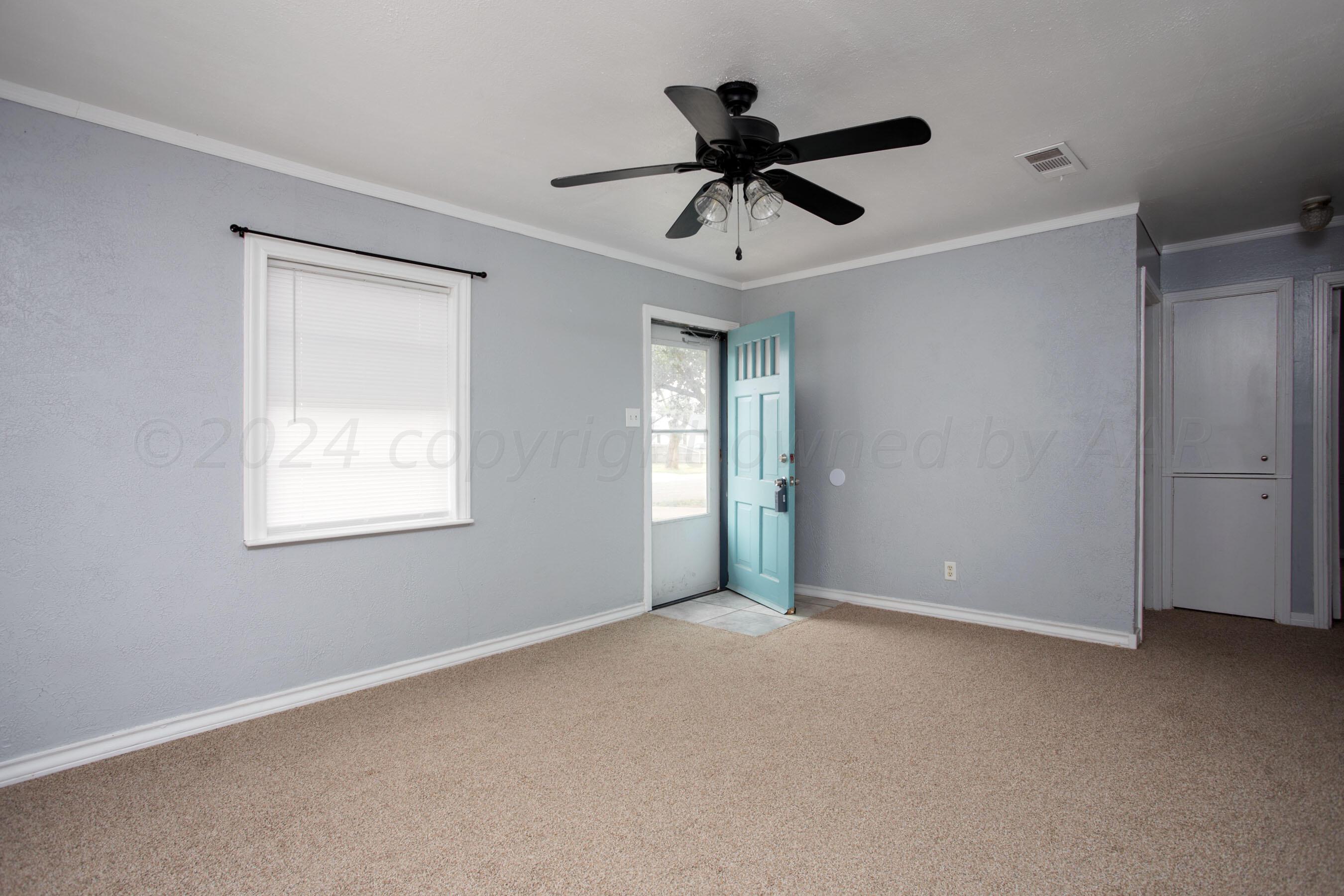 4432 South Travis Street Amarillo, TX 79110 - Photo 4 of 28 a view of an empty room with a window