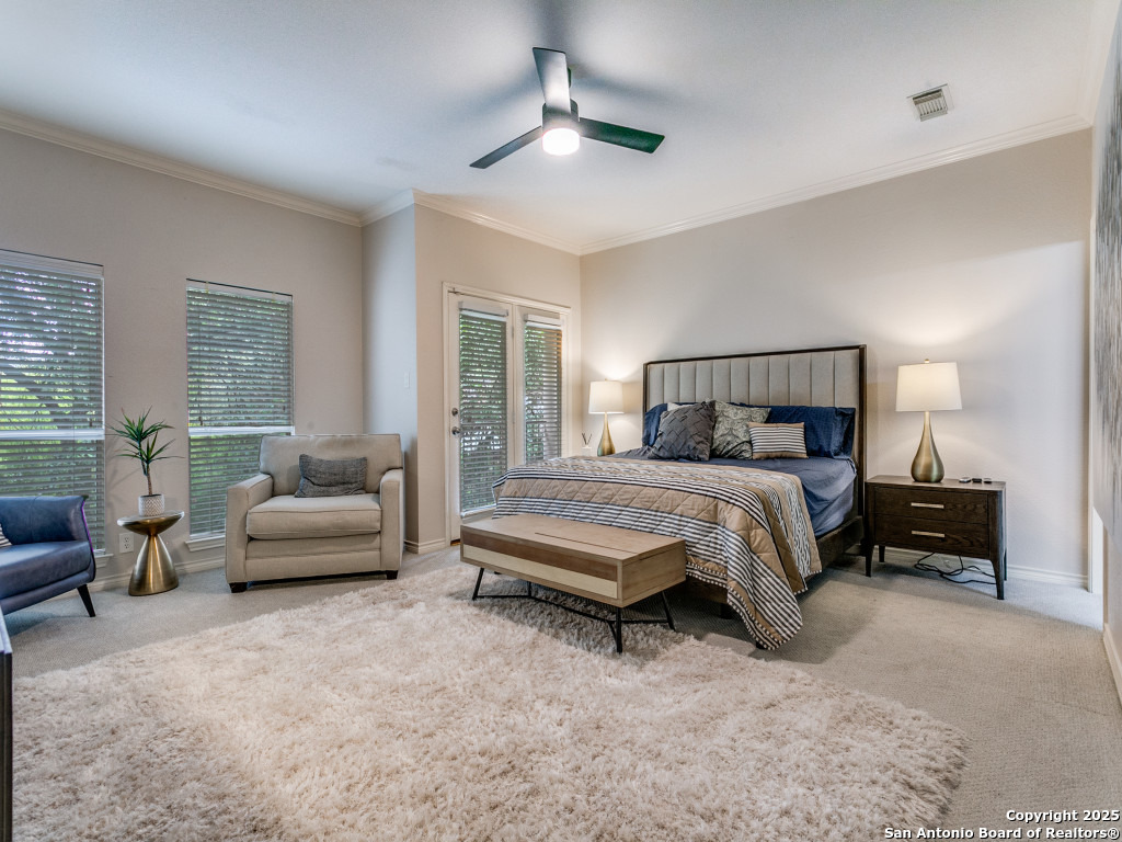 147 Elizabeth Road Alamo Heights, TX 78209 - Photo 18 of 25 a bedroom with a bed a couch and a chandelier fan