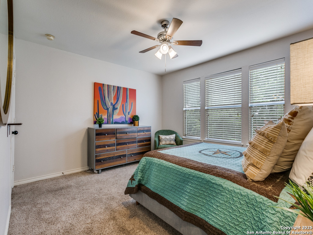 147 Elizabeth Road Alamo Heights, TX 78209 - Photo 21 of 25 a bedroom with a bed and a chandelier