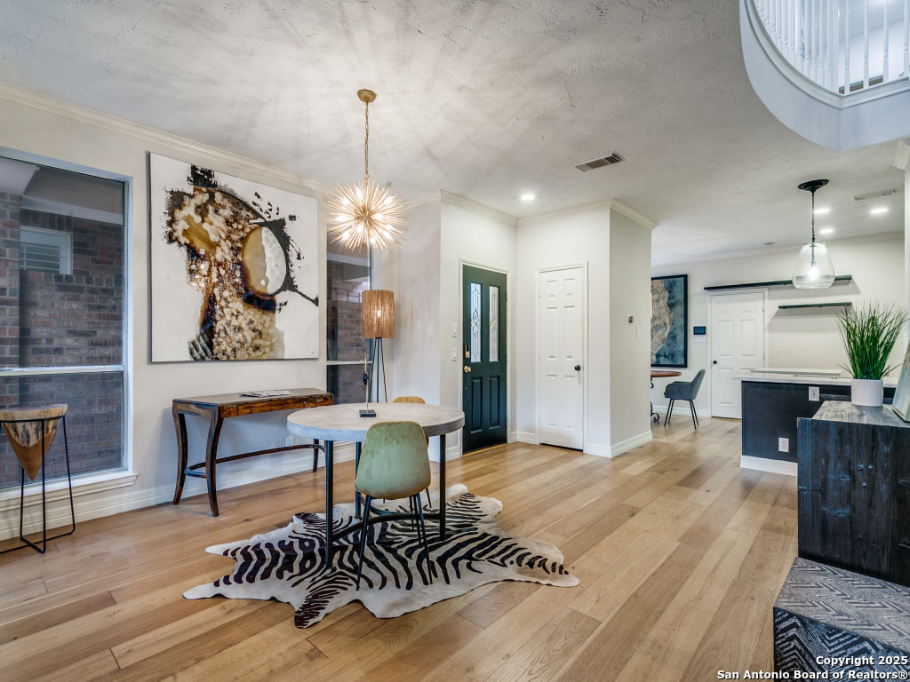147 Elizabeth Road Alamo Heights, TX 78209 - Photo 4 of 25 a living room with furniture a chandelier and a dining table