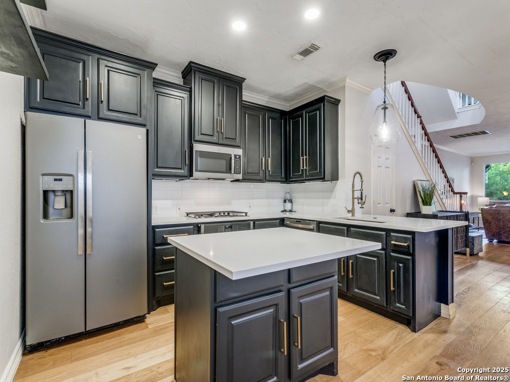 147 Elizabeth Road Alamo Heights, TX 78209 - Photo 10 of 25 a kitchen with stainless steel appliances granite countertop a sink stove and refrigerator