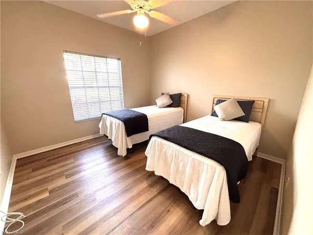 a bedroom with two beds and a chandelier