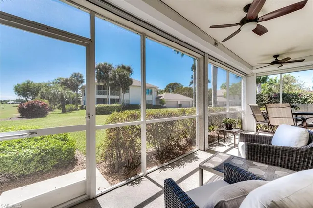 a living room with hardwood floor and ceiling windows