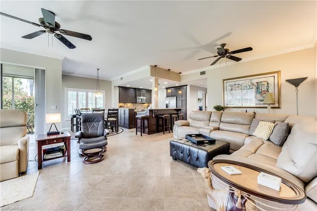 a living room with furniture ceiling fan and a rug