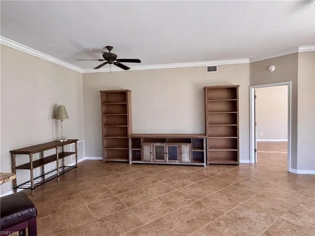 a view of a livingroom with furniture and a ceiling fan