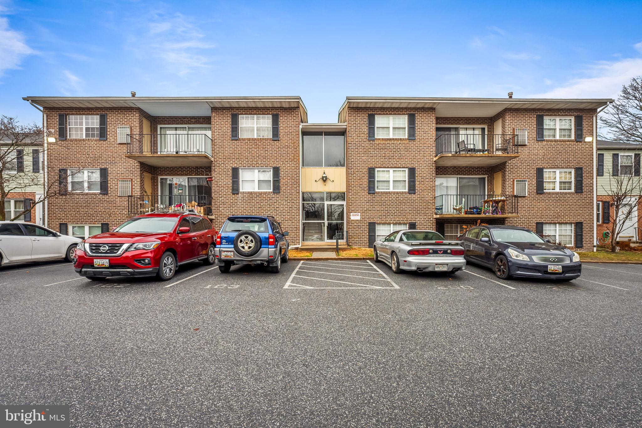 12 Cardor Court, Unit 100 Nottingham, MD 21236 - Photo 1 of 21 a car parked in front of a big white house