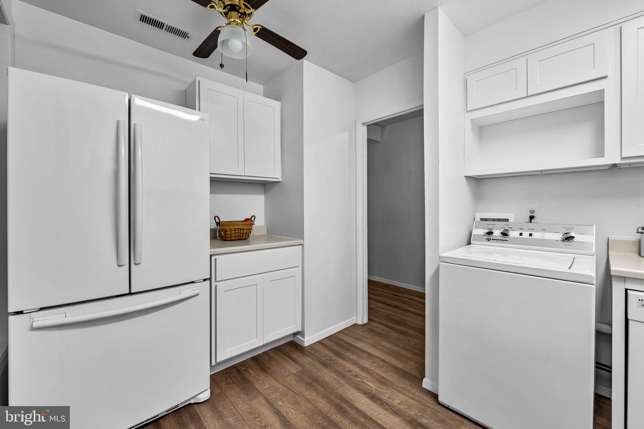12 Cardor Court, Unit 100 Nottingham, MD 21236 - Photo 11 of 21 a utility room with cabinets washer and dryer