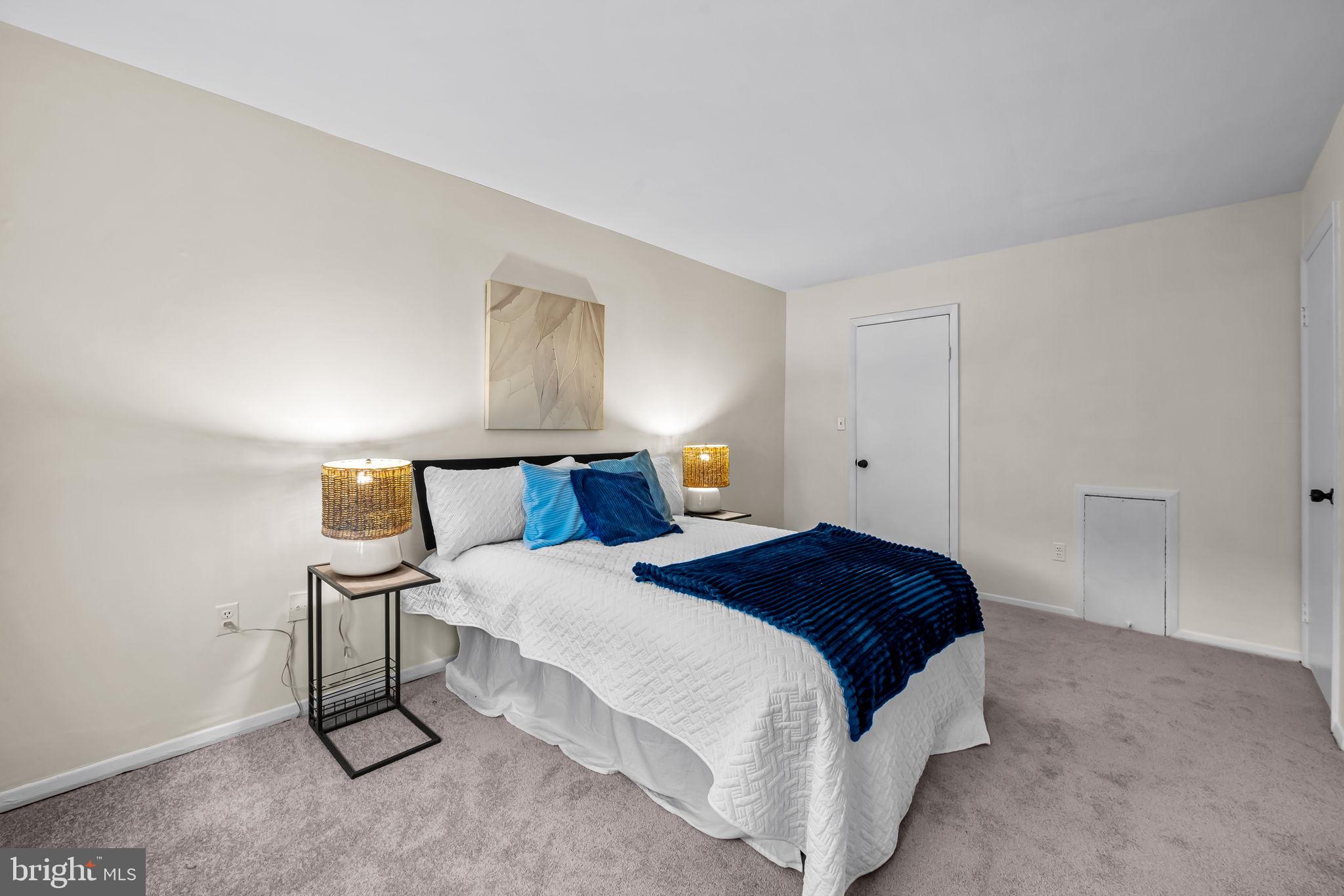 12 Cardor Court, Unit 100 Nottingham, MD 21236 - Photo 16 of 21 a bedroom with a bed and a night stand