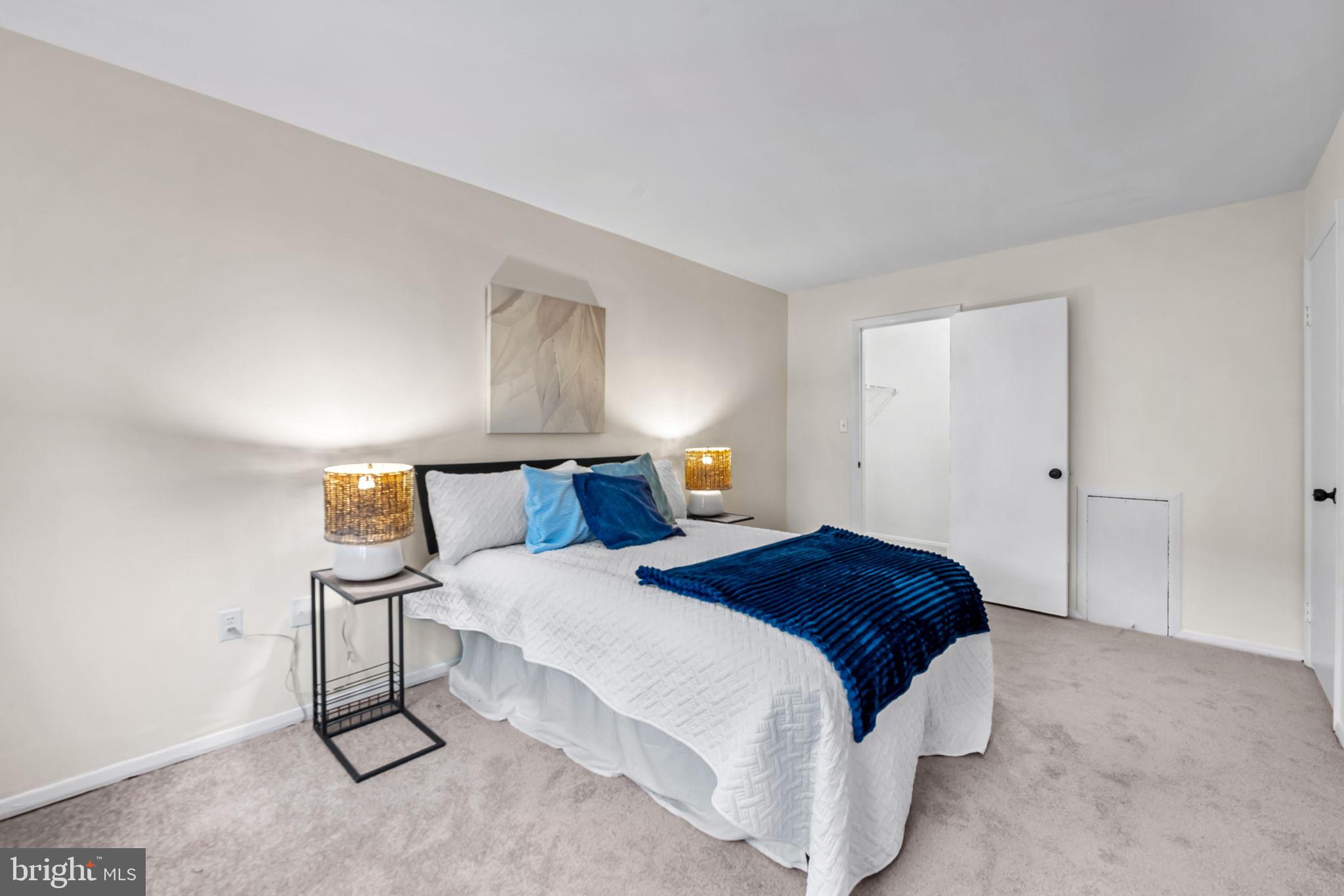 12 Cardor Court, Unit 100 Nottingham, MD 21236 - Photo 19 of 21 a bedroom with a bed and a night stand