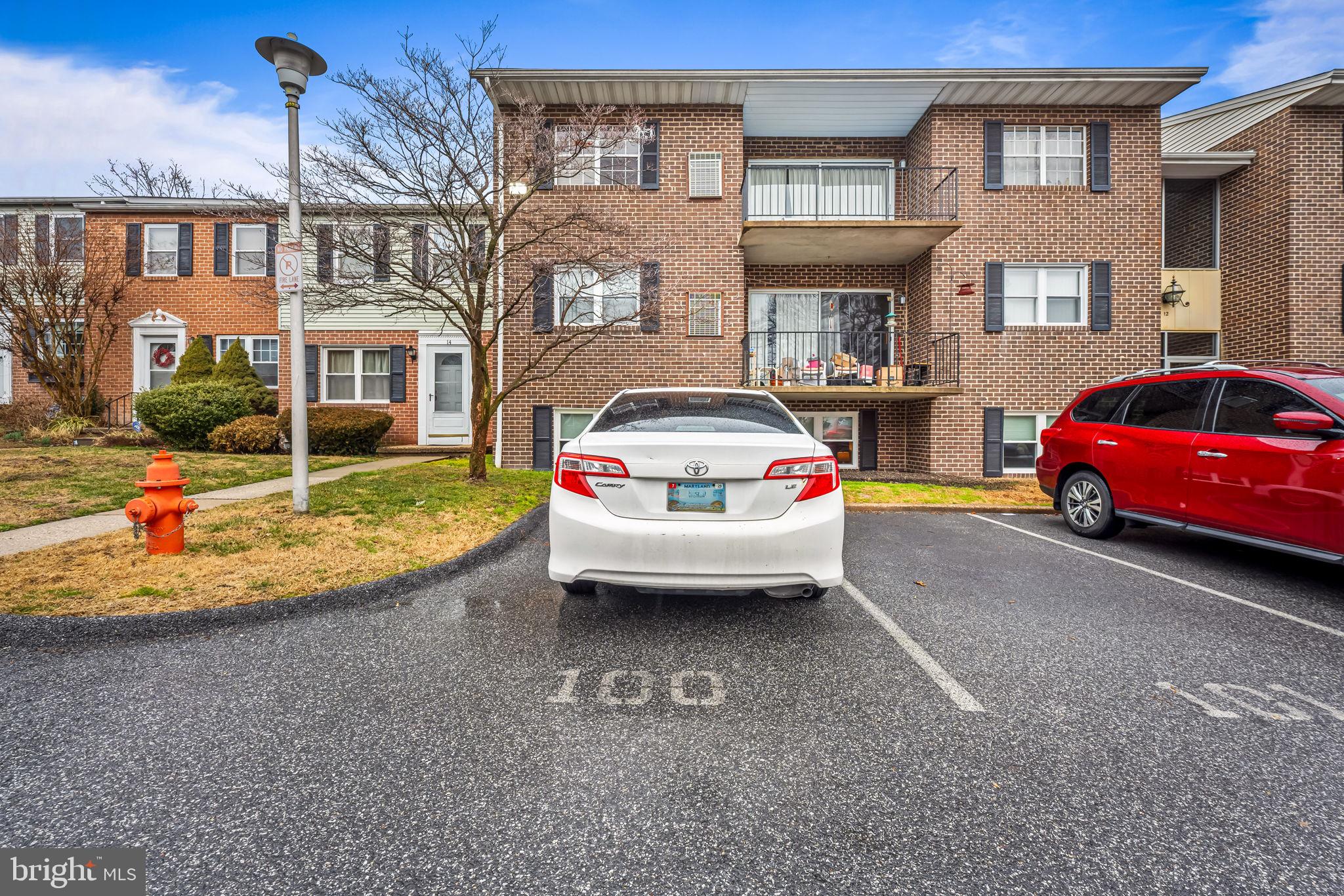 12 Cardor Court, Unit 100 Nottingham, MD 21236 - Photo 21 of 21 a view of a car park in front of a brick house