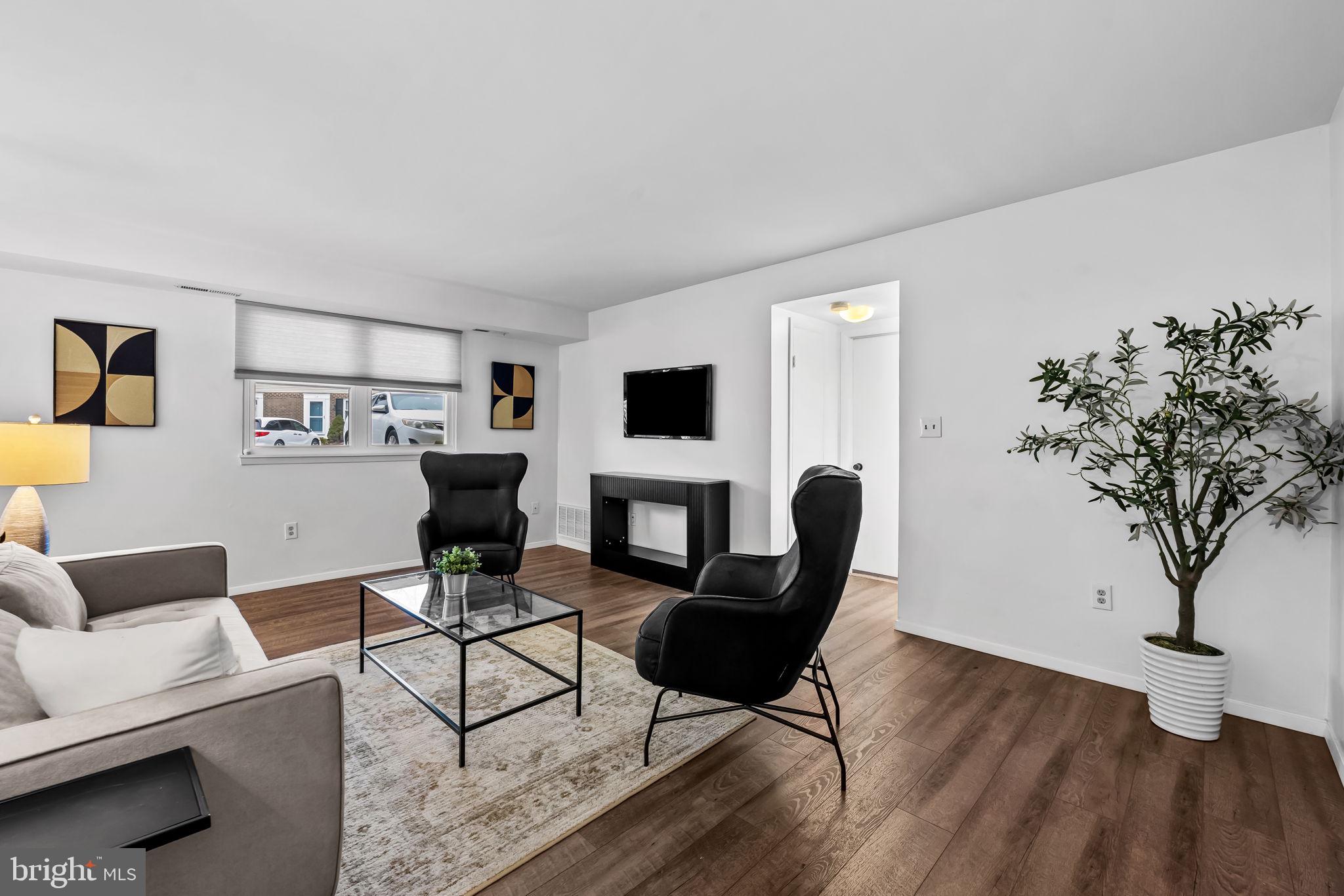 12 Cardor Court, Unit 100 Nottingham, MD 21236 - Photo 4 of 21 a living room with furniture and a potted plant