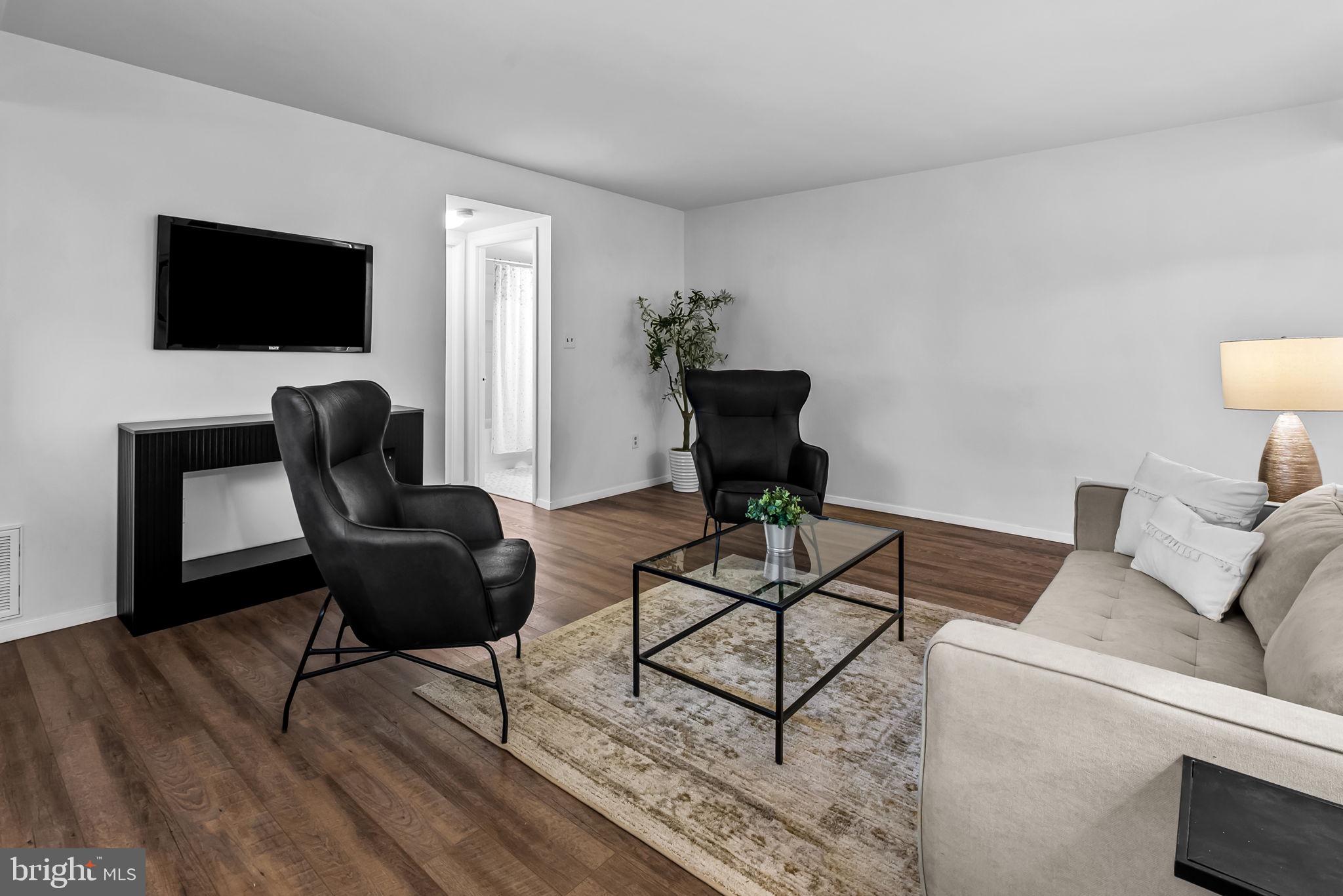 12 Cardor Court, Unit 100 Nottingham, MD 21236 - Photo 5 of 21 a living room with furniture and a flat screen tv