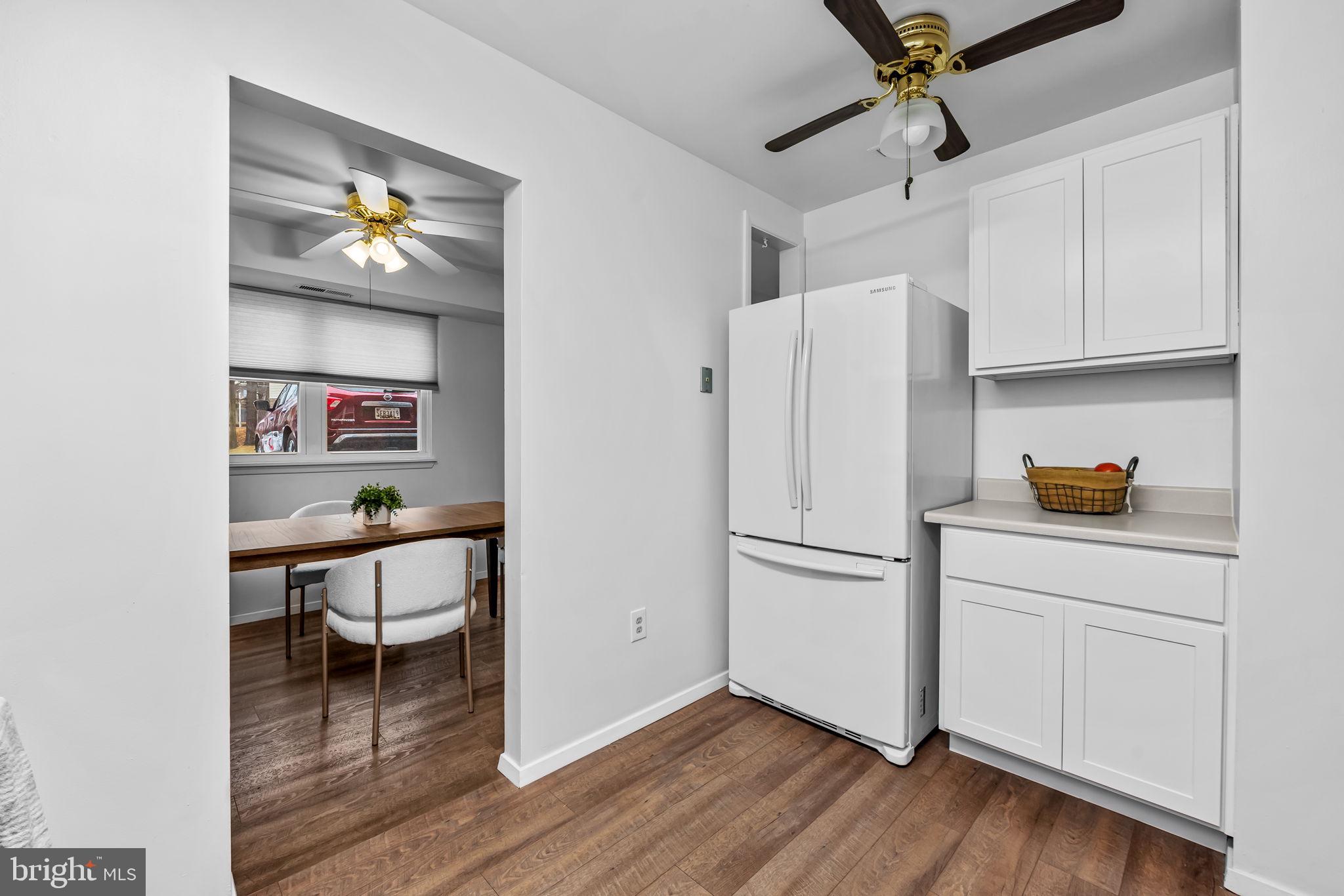 12 Cardor Court, Unit 100 Nottingham, MD 21236 - Photo 9 of 21 a kitchen with a refrigerator and white cabinets