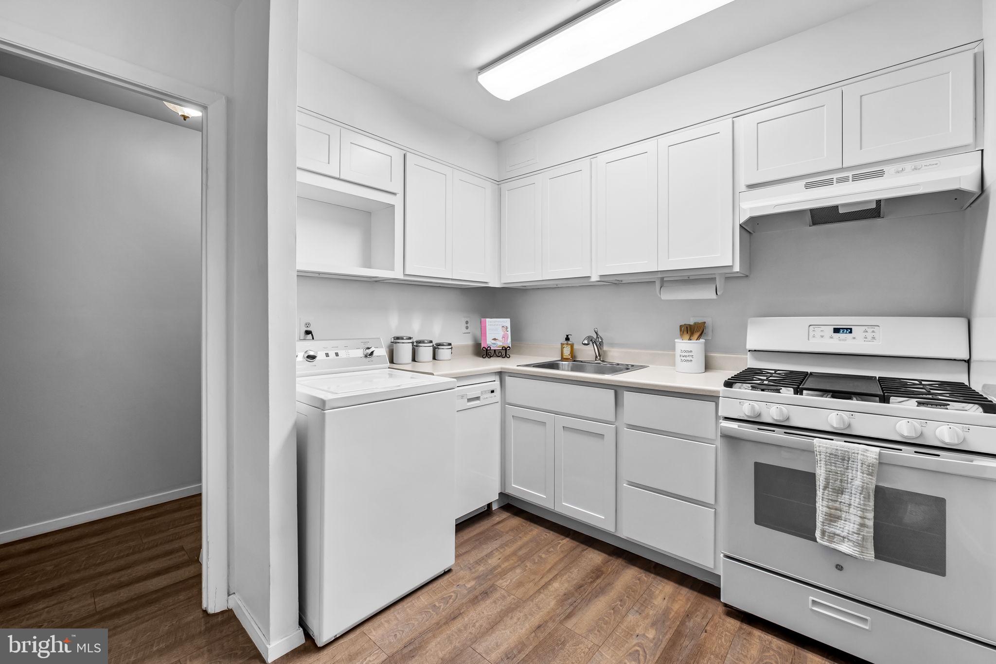 12 Cardor Court, Unit 100 Nottingham, MD 21236 - Photo 10 of 21 a kitchen with cabinets stainless steel appliances and wooden floor
