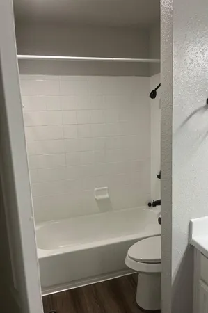 a bathroom with a shower a toilet and a shower