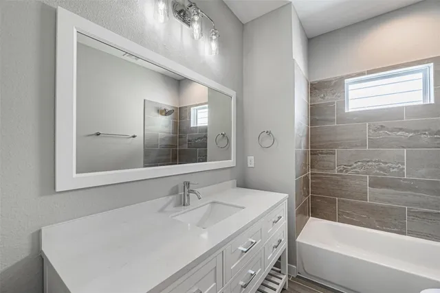 a bathroom with a sink double vanity granite tub and shower