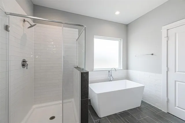 a bathroom with a bathtub and shower