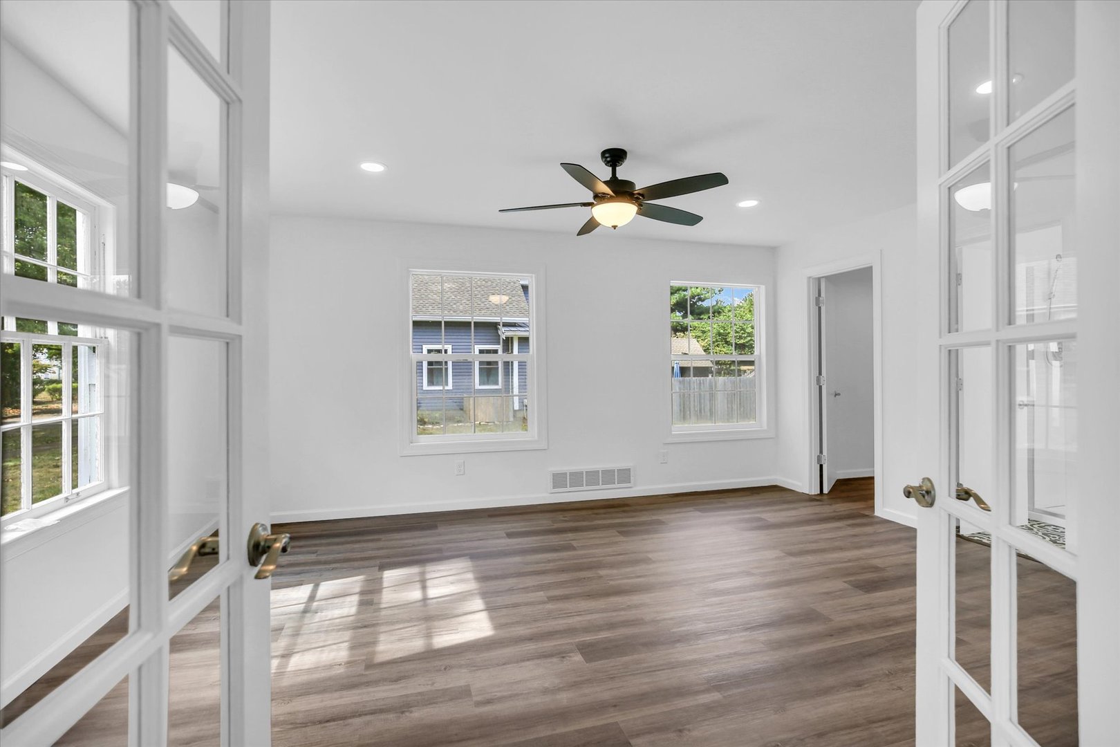 1212 West Healey Street Champaign, IL 61821 - Photo 23 of 63 a view of empty room with wooden floor and fan