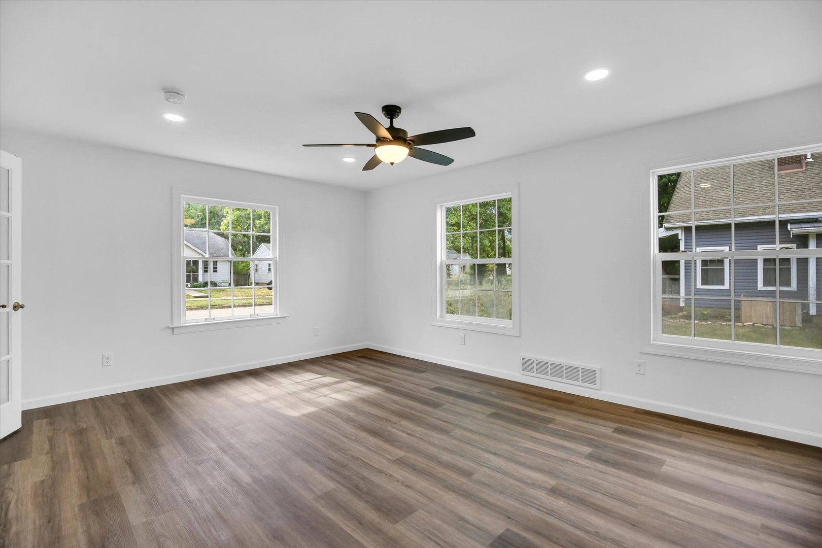 1212 West Healey Street Champaign, IL 61821 - Photo 26 of 63 a view of an empty room with a window and wooden floor