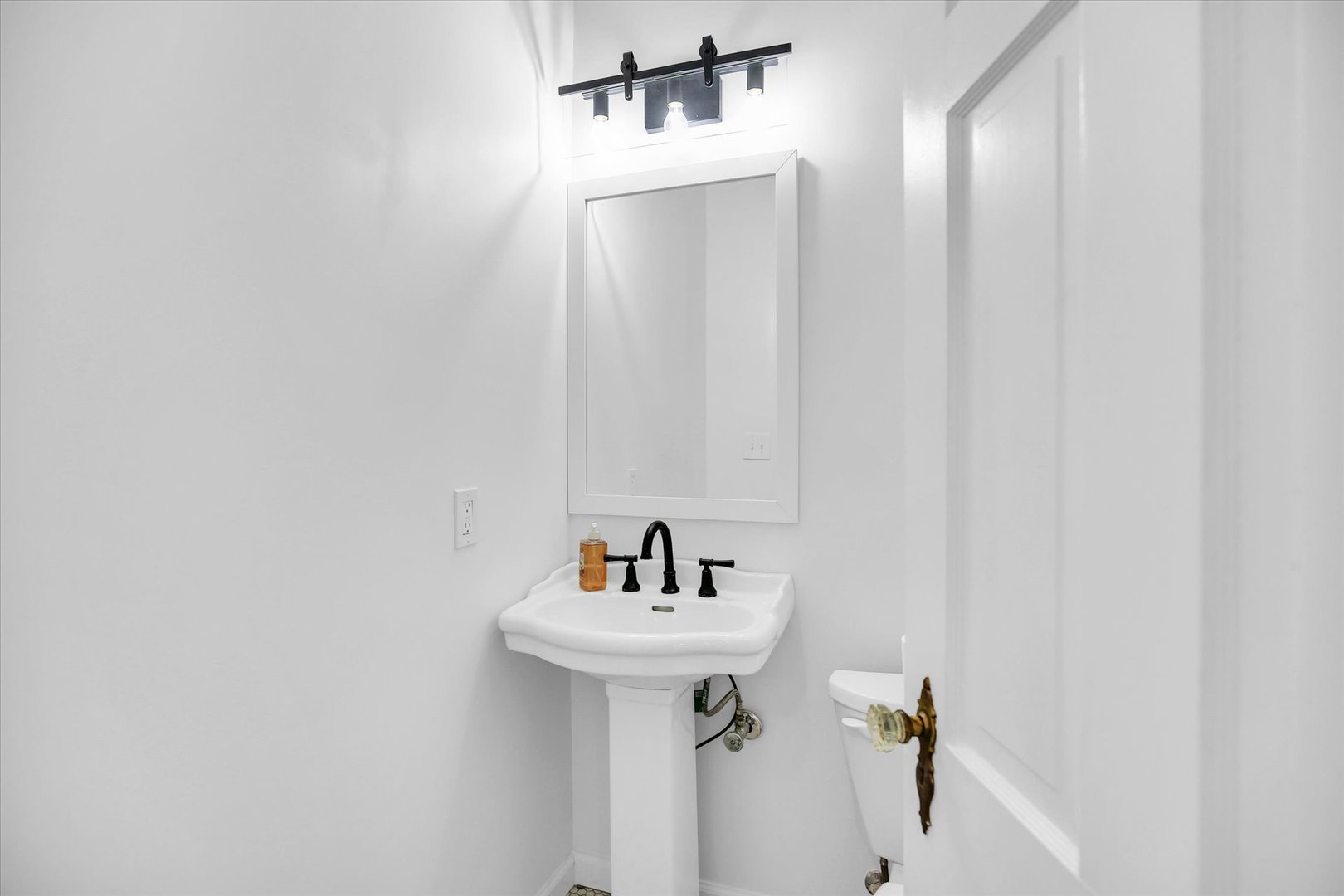 1212 West Healey Street Champaign, IL 61821 - Photo 29 of 63 a bathroom with a sink and mirror