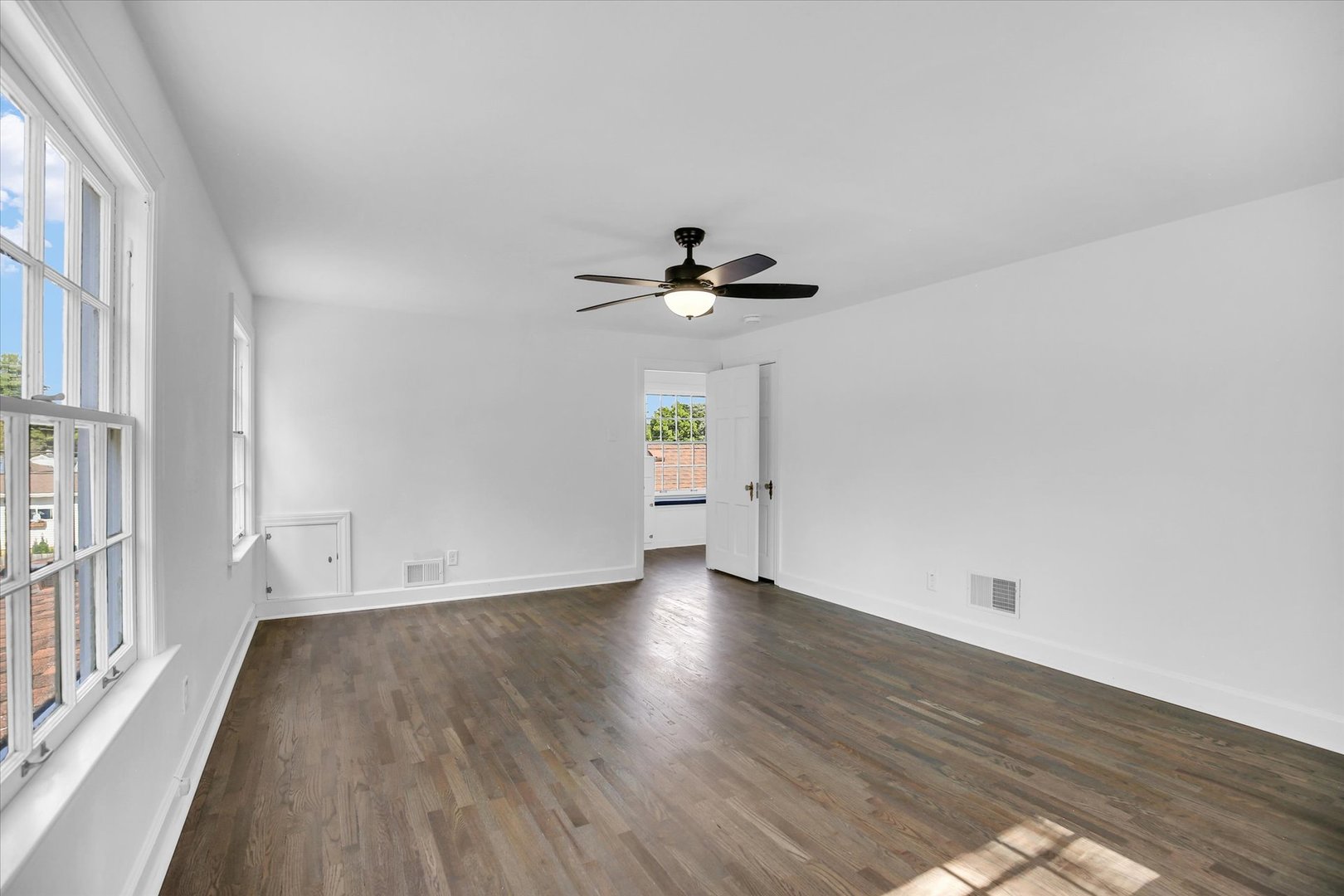 1212 West Healey Street Champaign, IL 61821 - Photo 42 of 63 a view of empty room with wooden floor and fan