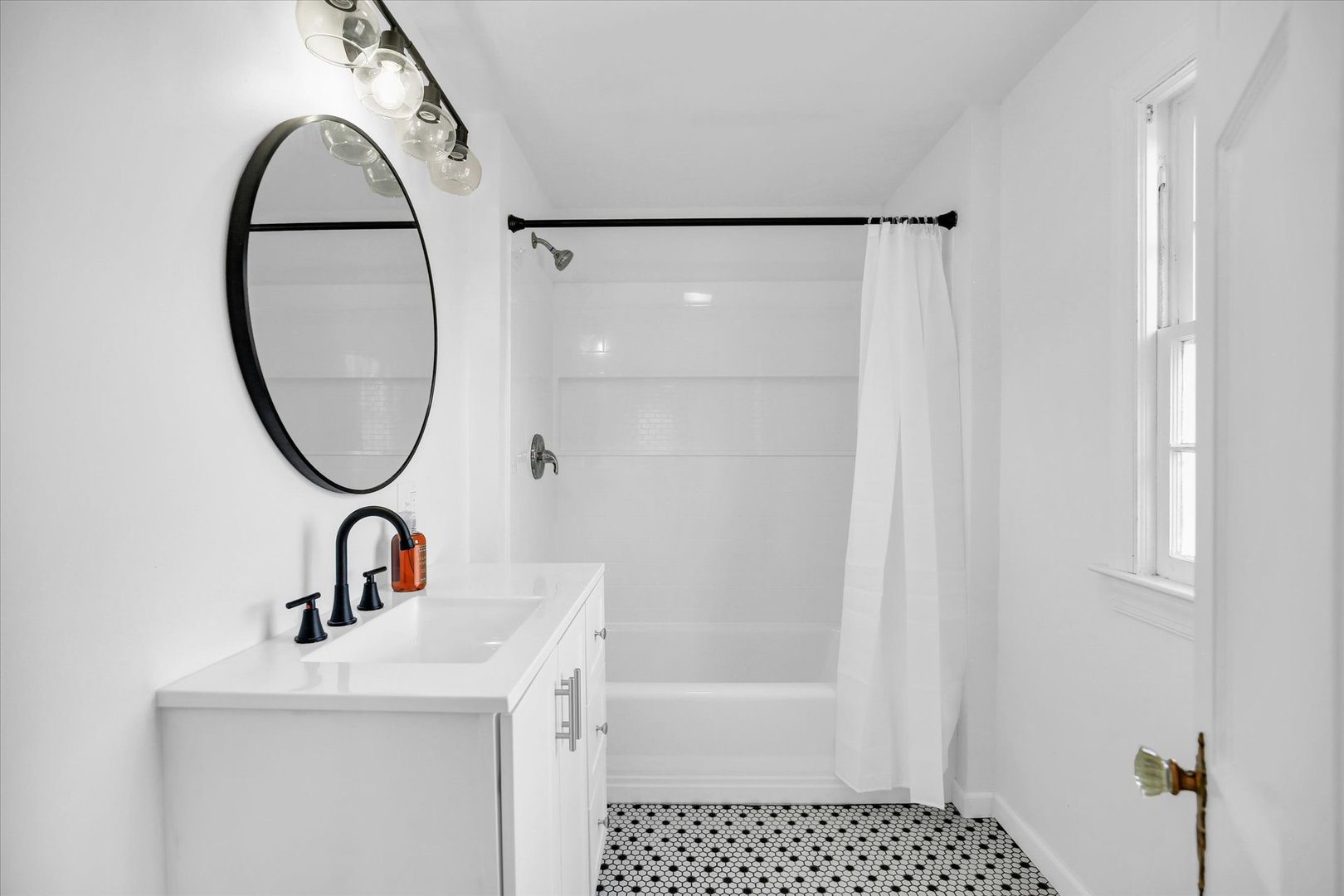 1212 West Healey Street Champaign, IL 61821 - Photo 45 of 63 a bathroom with a sink a mirror and a shower