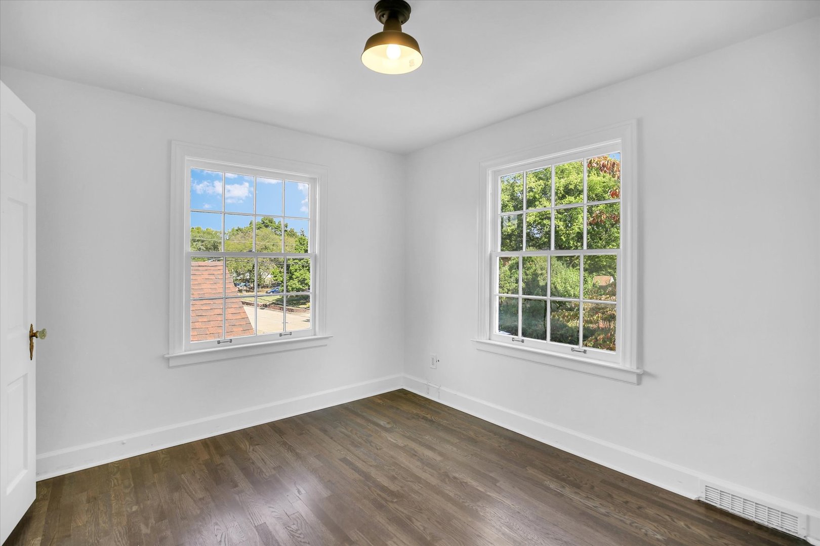 1212 West Healey Street Champaign, IL 61821 - Photo 47 of 63 an empty room with wooden floor and windows