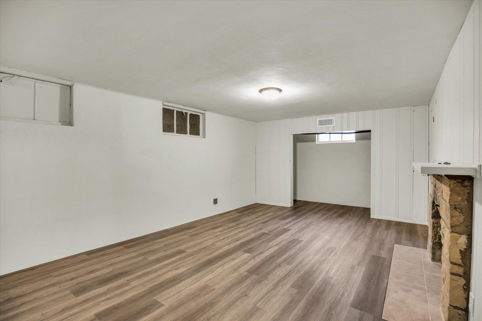 1212 West Healey Street Champaign, IL 61821 - Photo 53 of 63 wooden floor in an empty room with a fireplace