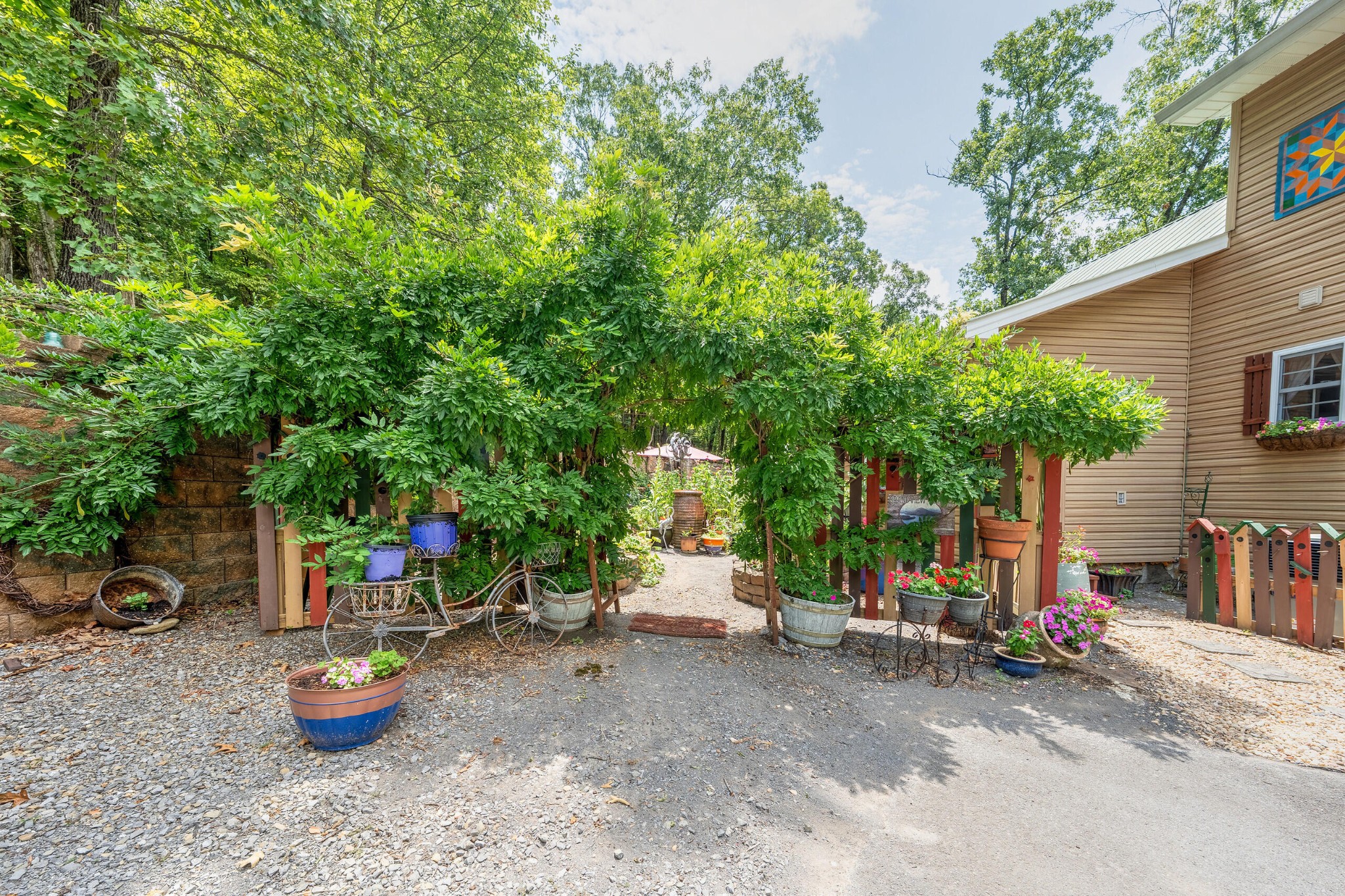260 Deer Ridge Trail Ocoee, TN 37361 - Photo 29 of 72 a view of a patio with table and chairs potted plants and a large tree