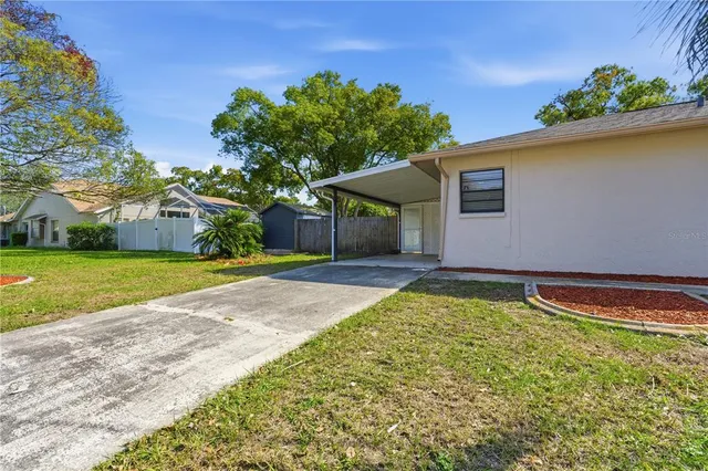 an empty room with a ceiling fan and carpet