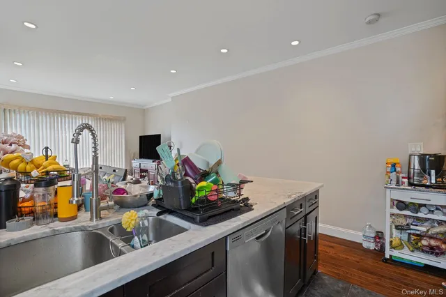 a kitchen with a stove a sink cabinets and a window