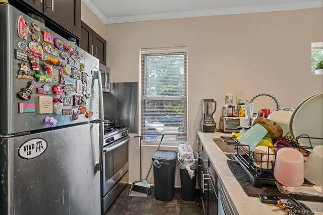 a kitchen with stainless steel appliances granite countertop a sink stove and refrigerator