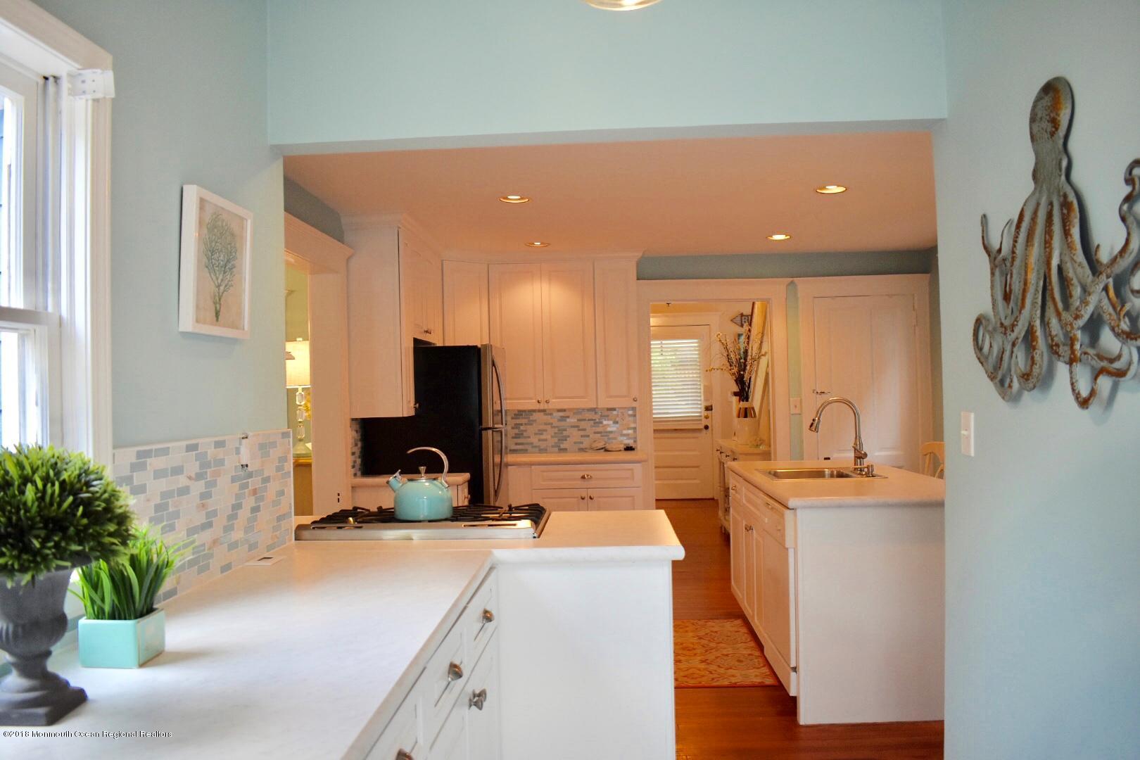 422 Worthington Avenue, Unit SUMMER 2026 Spring Lake, NJ 07762 - Photo 19 of 57 a large kitchen with kitchen island a counter top space a sink and appliances