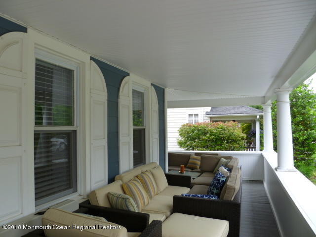 422 Worthington Avenue, Unit SUMMER 2026 Spring Lake, NJ 07762 - Photo 2 of 57 a balcony with furniture and a potted plant