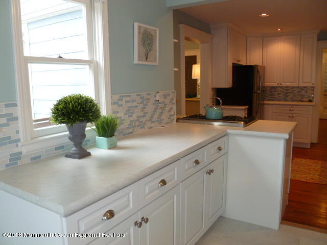 422 Worthington Avenue, Unit SUMMER 2026 Spring Lake, NJ 07762 - Photo 23 of 57 a bathroom with a sink a potted plant and a mirror
