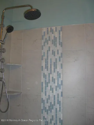 a bedroom with a bed and a lamp on the dresser