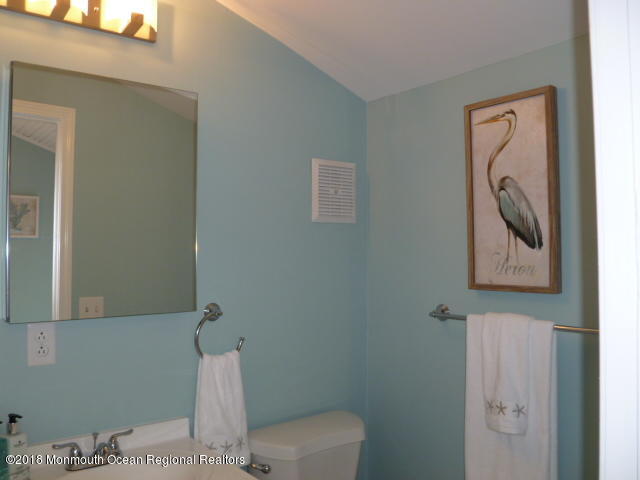 422 Worthington Avenue, Unit SUMMER 2026 Spring Lake, NJ 07762 - Photo 26 of 57 a white toilet sitting next to a bathroom sink