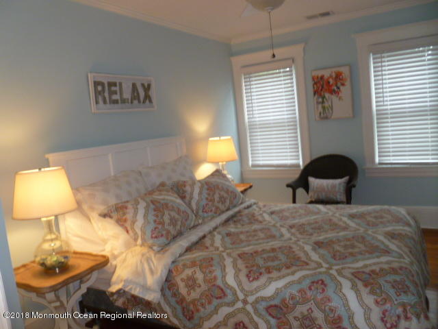 422 Worthington Avenue, Unit SUMMER 2026 Spring Lake, NJ 07762 - Photo 29 of 57 a bedroom with a bed and a lamp
